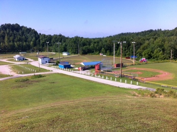 Photo of the Lee County Saddle club house arena and little league softball and baseball fields. 