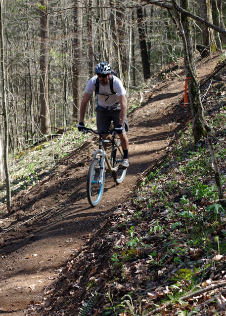 Mountain biker coasting downhill on a fresh trail in the Bald Rock area of the Pendergrass Murray Recreational Preserve. 